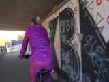 Watch Sandra riding her Bike in her sexy pink shiny nylon Rainsuit 5