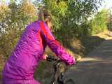 Watch Sandra riding her Bike in her sexy pink shiny nylon Rainsuit 7